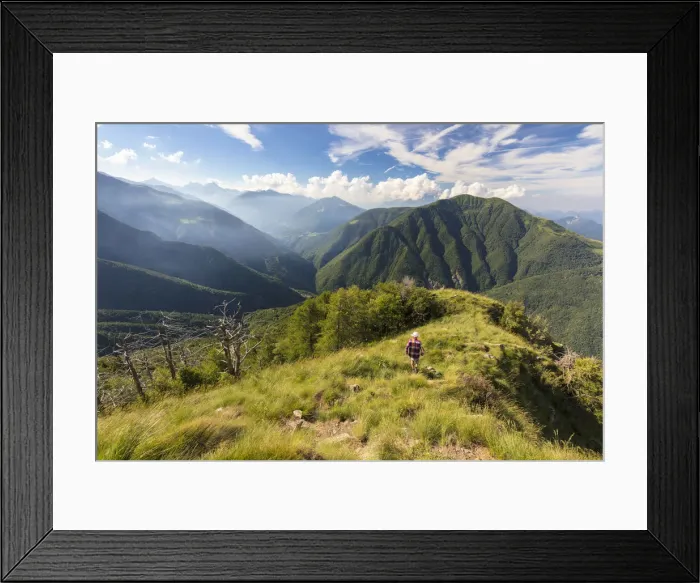 Framed Print : Hiker walks on Monte Legnoncino with Valvarrone and Valsassina in the background Framed Print : Hiker walks on Monte Legnoncino with Valvarrone and Valsassina in the background