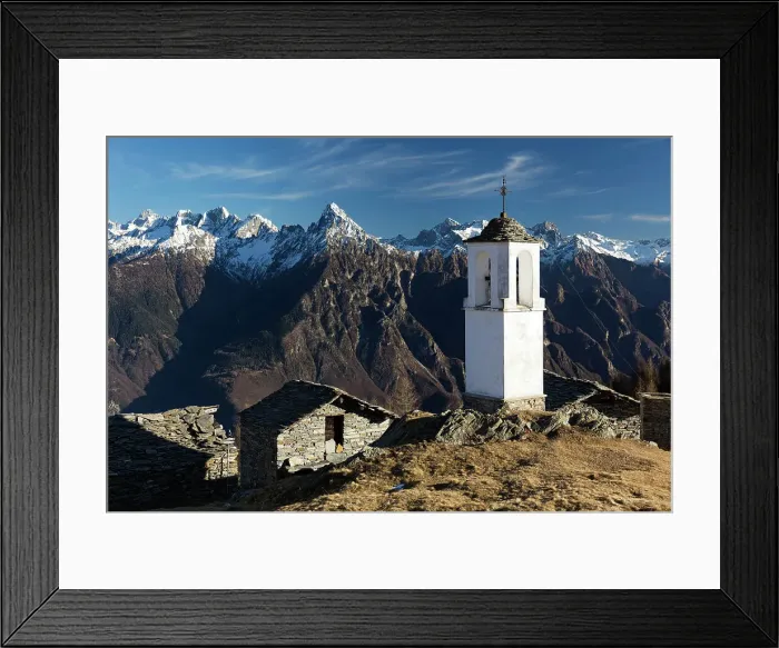 Framed Print : The bell tower of Alpe Scima, with Pizzo di Prata in the background, in winter Framed Print : The bell tower of Alpe Scima, with Pizzo di Prata in the background, in winter