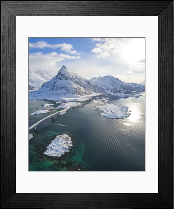 Framed Print : Aerial panoramic view of snowy peak of Volanstinden and Fredvang bridge, Lofoten Islands Framed Print : Aerial panoramic view of snowy peak of Volanstinden and Fredvang bridge, Lofoten Islands