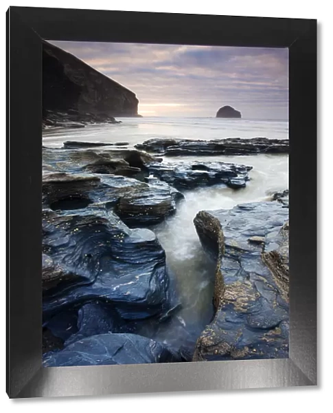 Eroded slate rocks on the beach at Trebarwith Strand, looking towards Gull Rock