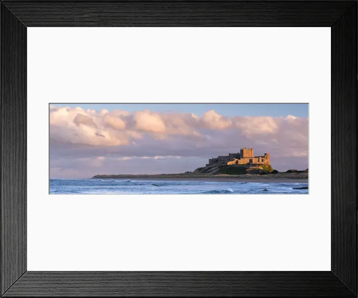 Framed Print : Late evening sunlight bathes against the Bamburgh Castle stronghold on the Northumberland Framed Print : Late evening sunlight bathes against the Bamburgh Castle stronghold on the Northumberland