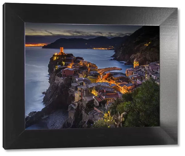 Vernazza, Liguria, Italy. View of the village during sunset, with trees on the foreground