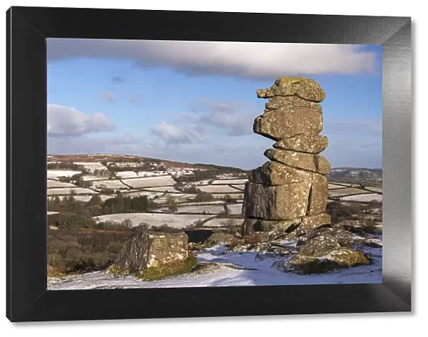 The Bowermans Nose granite pillar surrounded by some light winter snow, Dartmoor