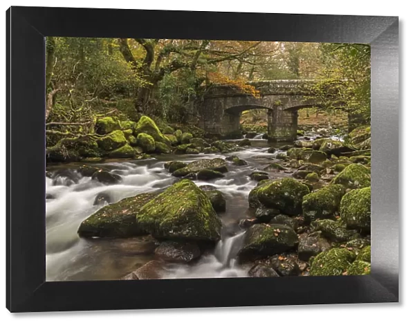 Stone bridge spanning the River Plym in Dartmoor National Park, Devon, England. Autumn