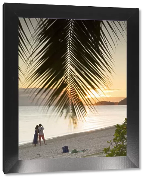 Couple on Matira Beach at sunset, Bora Bora, Society Islands, French Polynesia
