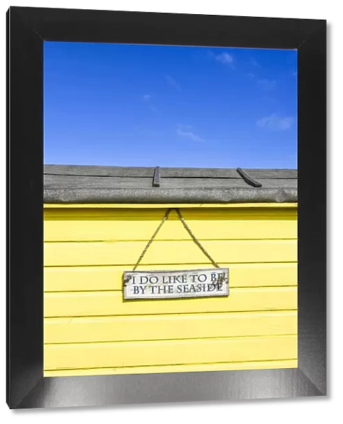 'I do like to be beside the seaside' traditional beach hut on Littlestone beach, Kent, England