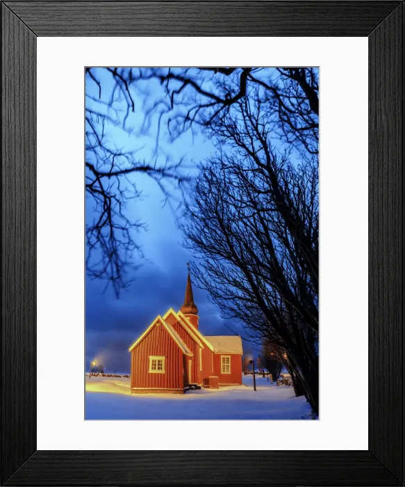 Framed Print : Lights on the church at dusk with the snowy peaks in the background Flakstad Lofoten Framed Print : Lights on the church at dusk with the snowy peaks in the background Flakstad Lofoten