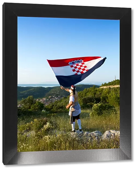 Europe, Croatia, Dalmatia, Korcula Island, Blato, a local in traditional dress waving
