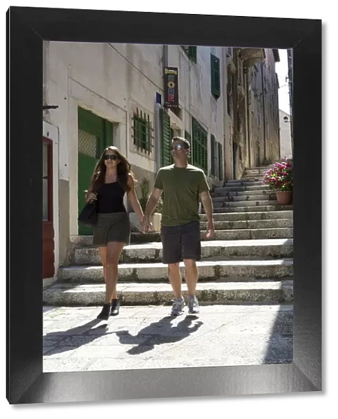 Europe, Croatia, Dalmatia, Korcula island, Korcula town, a couple walking through
