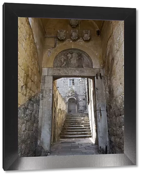 Europe, Croatia, Dalmatia, Dubrovnik, a gate and stone stairway in the historic centre