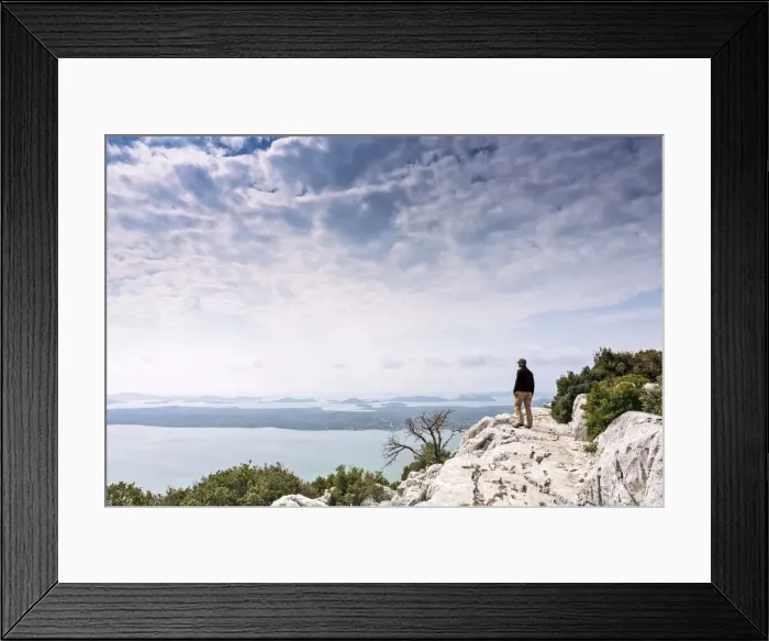 Framed Print : Europe, Croatia, Dalmatia, Zadar county, Kamenjak viewpoint, a hiker looking out over