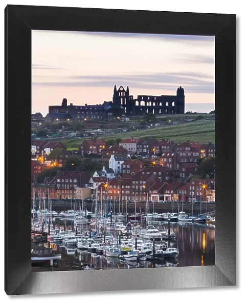 United Kingdom, England, North Yorkshire, Whitby. The Abbey and harbour before sunrise