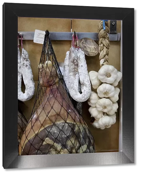 Provence, France. Meat hanging with garlic in a traditional deli in the South of France