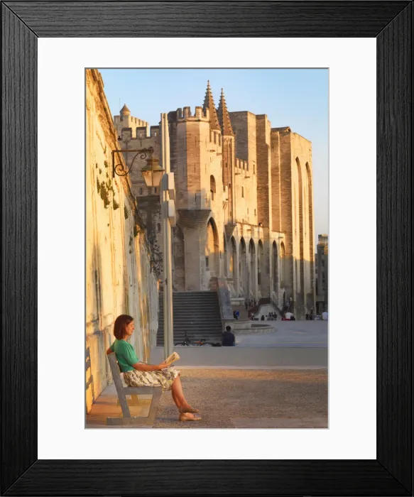 Framed Print : France, Provence, Avignon, Palais de Papes, Woman reading book on bench MR