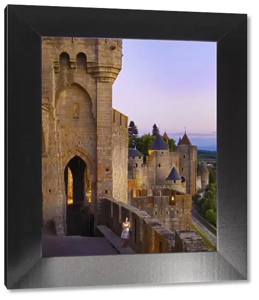 France, Languedoc, Carcassonne, Woman looking at view from walls at dusk (MR)