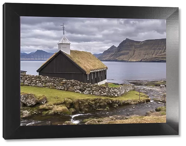 Traditional grass roofed Faroese church in the village of Funningur on the island