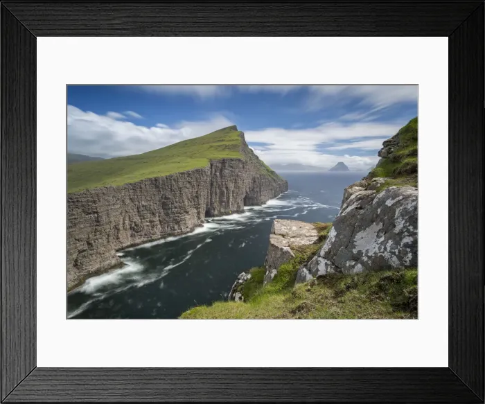 Framed Print : Towering sea cliffs on the island of Vagar in the Faroe Islands, Denmark. Summer Framed Print : Towering sea cliffs on the island of Vagar in the Faroe Islands, Denmark. Summer