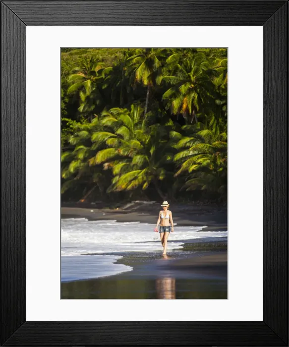 Framed Print : Dominica, Hampstead. A woman walks along No 1 Beach. (MR) Framed Print : Dominica, Hampstead. A woman walks along No 1 Beach. (MR)