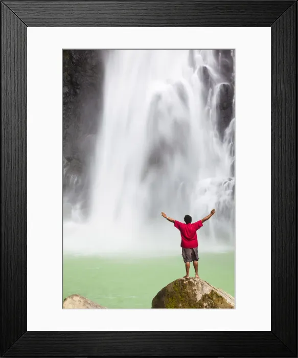 Framed Print : Dominica, Delices. A man stands at the base of Victoria Falls, one of the tallest Framed Print : Dominica, Delices. A man stands at the base of Victoria Falls, one of the tallest