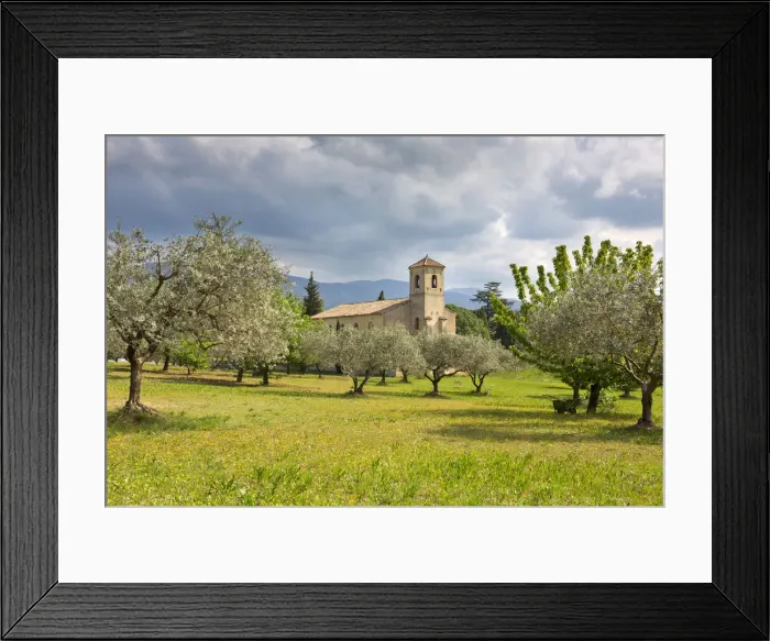 Framed Print : Gothic church of Saint-Andra -et-Saint-Trophime surrounded by olive trees, Lourmarin Framed Print : Gothic church of Saint-Andra -et-Saint-Trophime surrounded by olive trees, Lourmarin