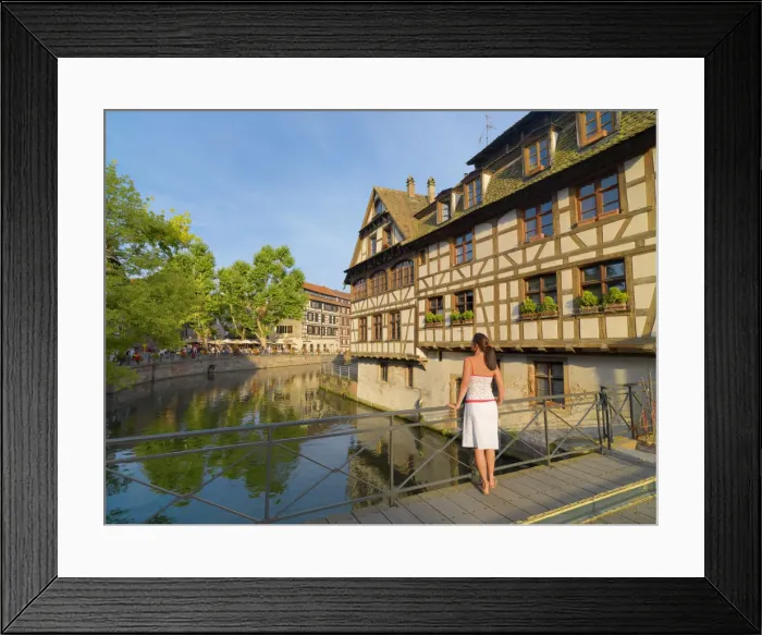 Framed Print : France, Alsace, Strasbourg, La-Petie-France, Woman looking at view (MR) Framed Print : France, Alsace, Strasbourg, La-Petie-France, Woman looking at view (MR)