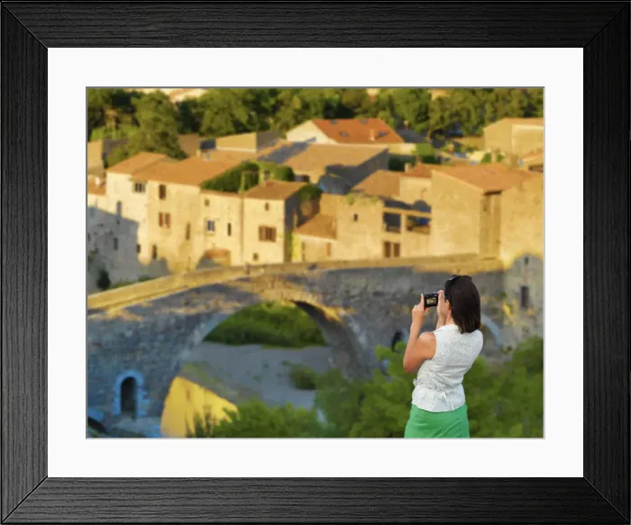 Framed Print : France, Languedoc, Lagrasse, woman photographing bridge (MR)