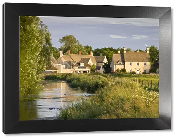 Cottages near the River Coln at Fairford in the Cotswolds, Gloucestershire, England
