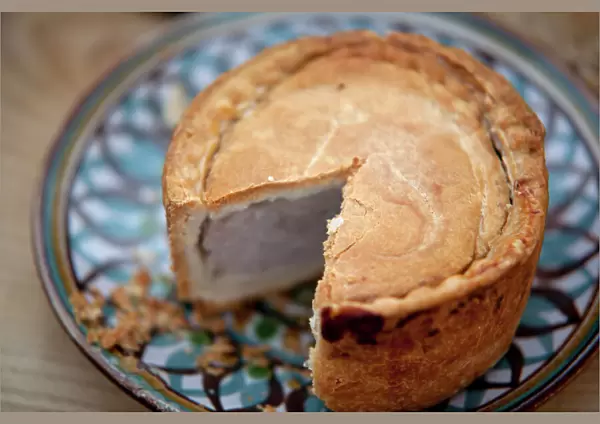 Nottinghamshire, UK. Melton Mowbray pork pie on handmade ceramic plate