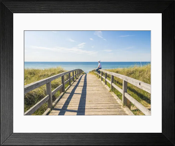 Framed Print : Man standing on a footbridge to Weissenhaauser Strand, Ostholstein, Schleswig-Holstein Framed Print : Man standing on a footbridge to Weissenhaauser Strand, Ostholstein, Schleswig-Holstein