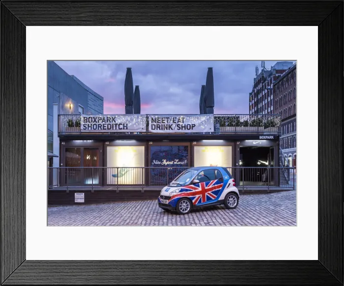 Framed Print : United Kingdom, UK, England, A Smart car with english flag in front of one Nike shop
