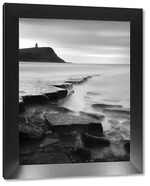 Rocks in Kimmeridge Bay with Clavell Tower in the background, Dorset, UK