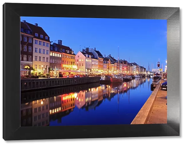 Europe, Denmark, Zealand, Copenhagen, a night time shot of colourful houses in Nyhavn