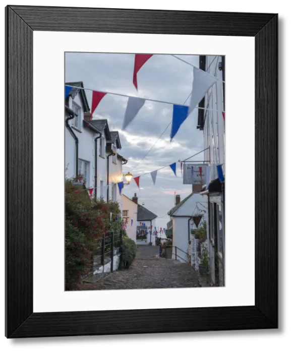 Framed Print : Bunting above the cobbled streets of Clovelly at dawn, North Devon, England. Summer Framed Print : Bunting above the cobbled streets of Clovelly at dawn, North Devon, England. Summer