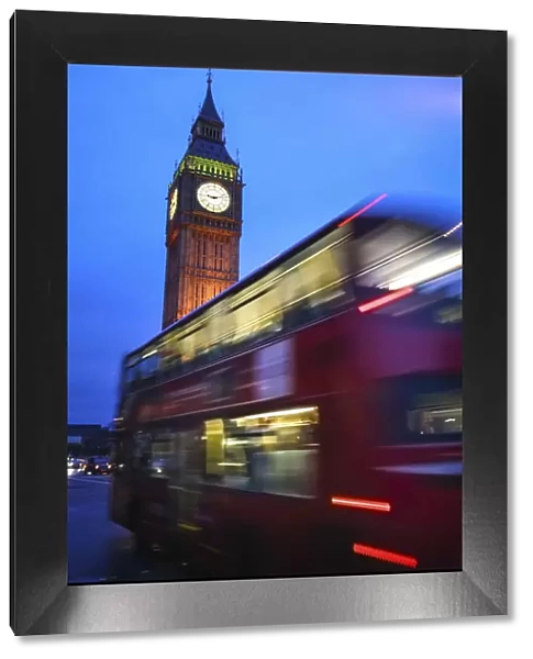 London, UK, Double Decker red bus passing in front of the Big Ben illuminated at dusk