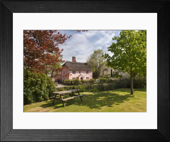 Framed Print : Picnic bench and pretty pink cottage in the village of Winsford, Exmoor National Park