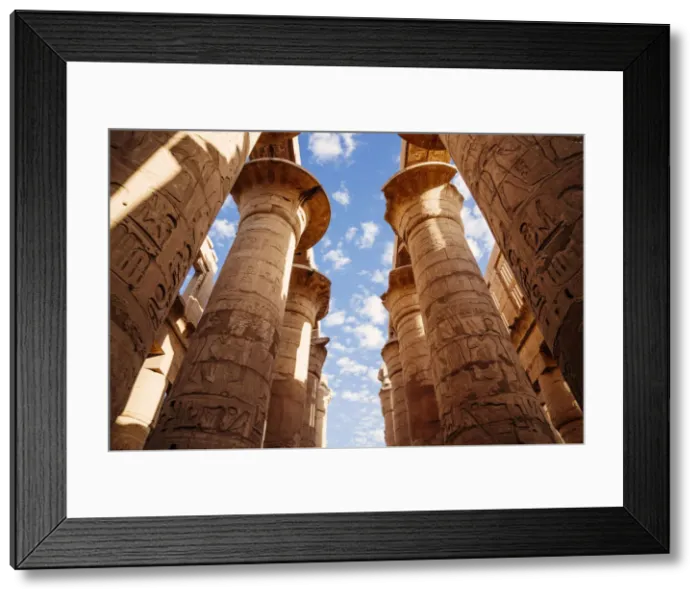 Framed Print : Columns and blue sky at Great hypostyle hall in the Precinct of Amun Re - Karnak Temple