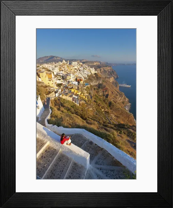 Framed Print : Greece, The Cyclades, Santorini (Thira), Fira, Woman sitting on wall in town (MR)
