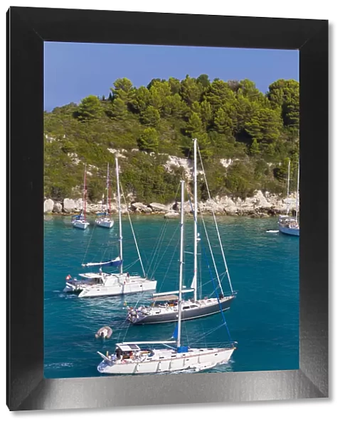 Western Europe, Greece, Ionian Islands, Paxos. Yachts leaving the harbour at Lakka