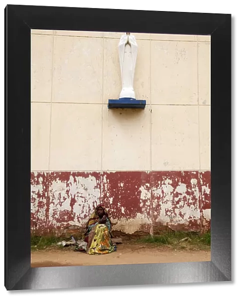 Bujumbura, Burundi. A woman begs outside a convent school