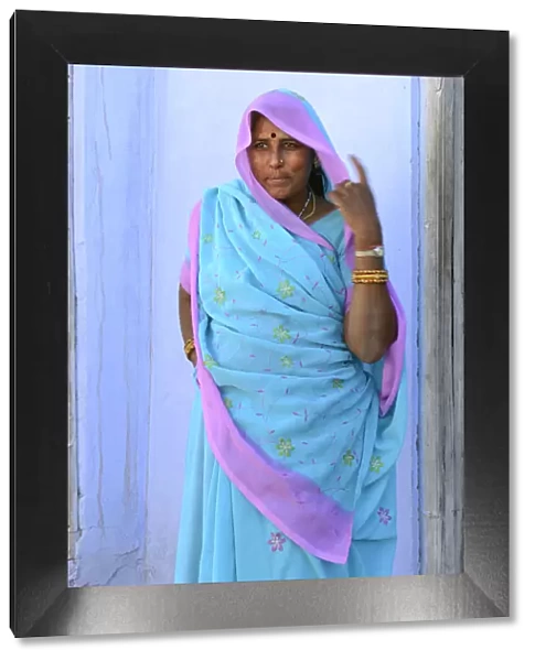 Woman in brightly coloured sari in the Village of Pachewar, Rajasthan, India, Asia