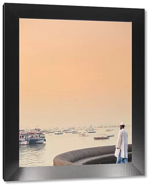 India, Maharashtra, Mumbai, a Muslim man watching sunrise over Mumbai harbour