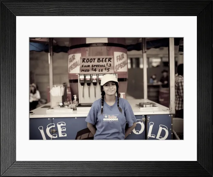 Framed Print : A young girl selling root beer at a midway concession at the Calgary Stampede, Canada