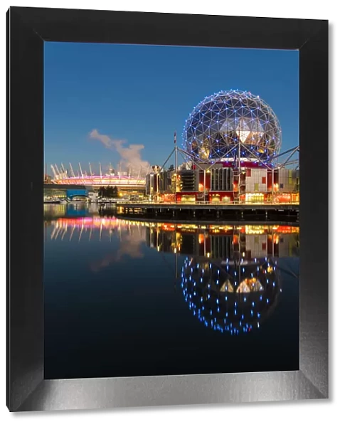 Sunrise view of False Creek inlet with Telus World of Science and BC Place Stadium behind