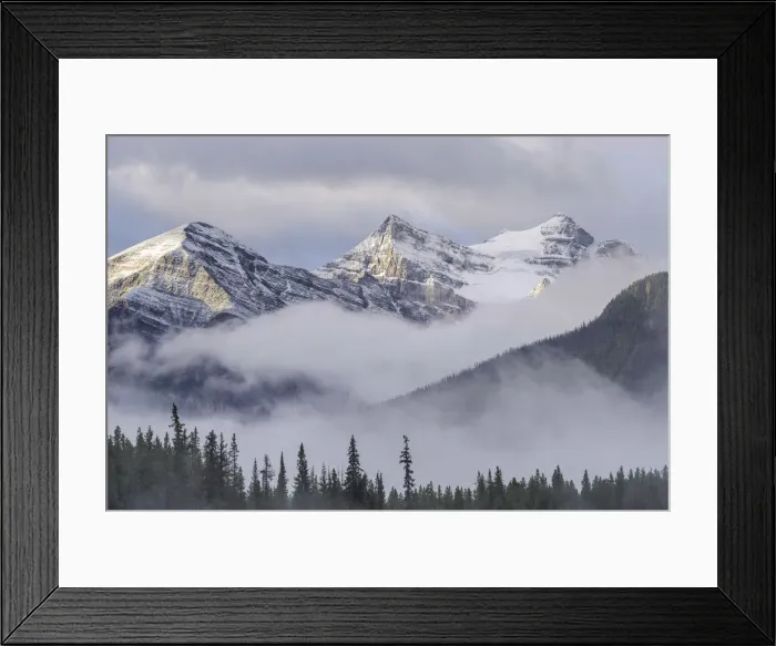 Framed Print : Early morning mist hangs in the wooded valleys below the snow capped mountains of Framed Print : Early morning mist hangs in the wooded valleys below the snow capped mountains of