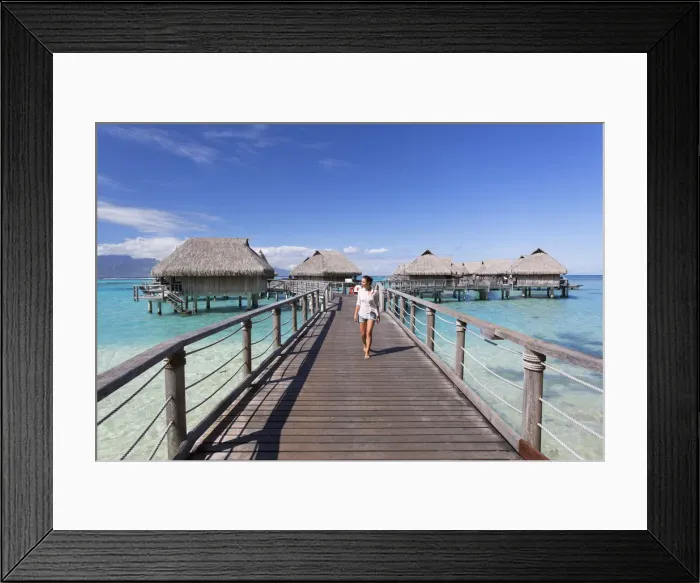 Framed Print : Woman walking on jetty of overwater bungalows of Sofitel Hotel, Moorea, Society Islands Framed Print : Woman walking on jetty of overwater bungalows of Sofitel Hotel, Moorea, Society Islands