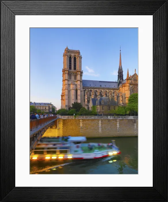 Framed Print : France, Paris, Notre Dame Cathedral and tour boat on River Seine at dusk Framed Print : France, Paris, Notre Dame Cathedral and tour boat on River Seine at dusk