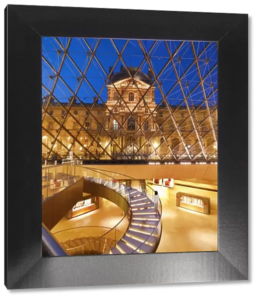 France, Paris, The Louvre, interior of museum illuminated at night(