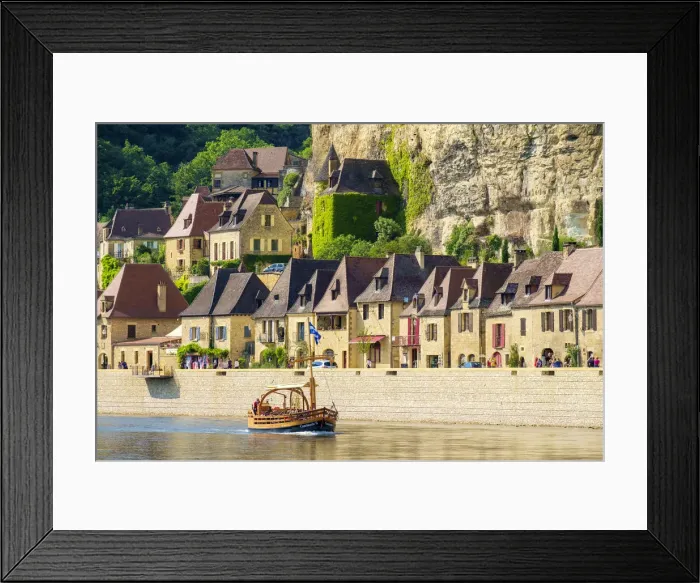 Framed Print : Tourist boat passing in front of old stone houses on Dordogne River in late afternoon Framed Print : Tourist boat passing in front of old stone houses on Dordogne River in late afternoon