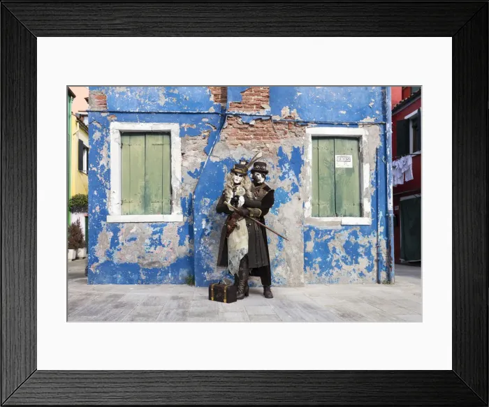 Framed Print : Couple in steampunk costumes in front of old blue house at Carnival time, Burano Island Framed Print : Couple in steampunk costumes in front of old blue house at Carnival time, Burano Island