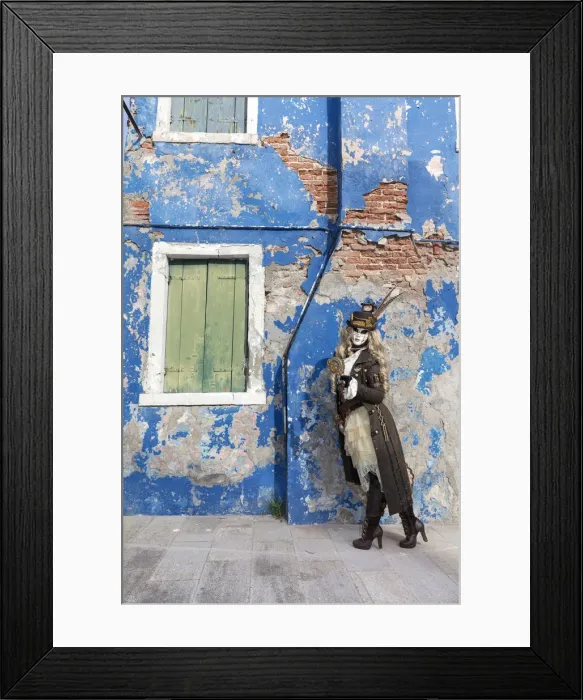 Framed Print : Woman in steampunk costume posing in front of old blue house, Burano Island, Venice Framed Print : Woman in steampunk costume posing in front of old blue house, Burano Island, Venice